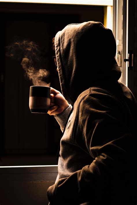 person drinking coffee   window  stock photo