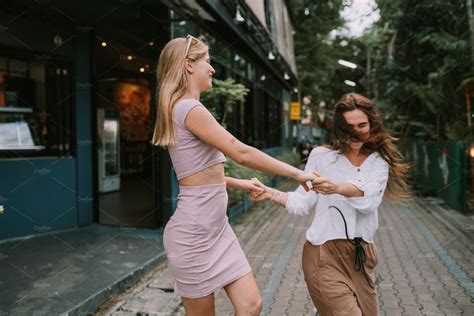 two lesbians having fun on the street people images ~ creative market