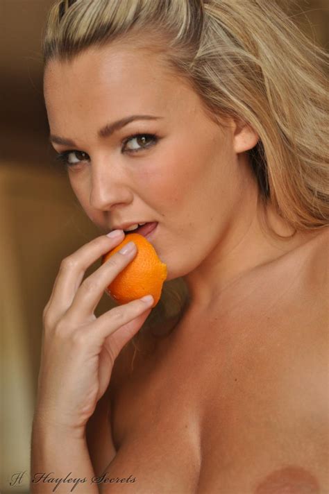 nude titted and pantieless blonde jodie gasson is erotically eating the orange