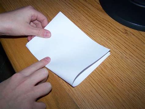 man manages   fold  piece  paper  times   row