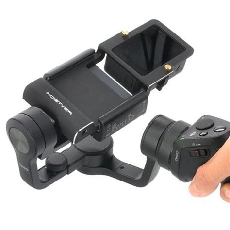 hand holding  camera   small lens attached      holder