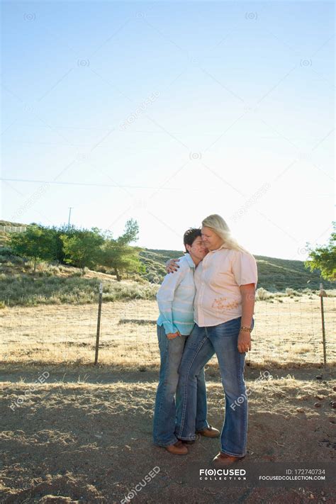 Mature Lesbian Couple Embracing On Ranch — 45 To 49 Years Homosexual