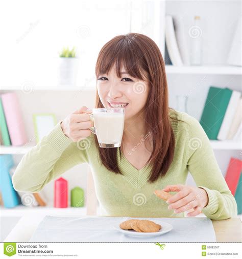 asian female drinking milk stock image image of home