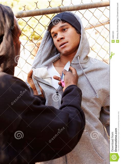 Man Being Threatened With Knife By Gang Member Stock Image