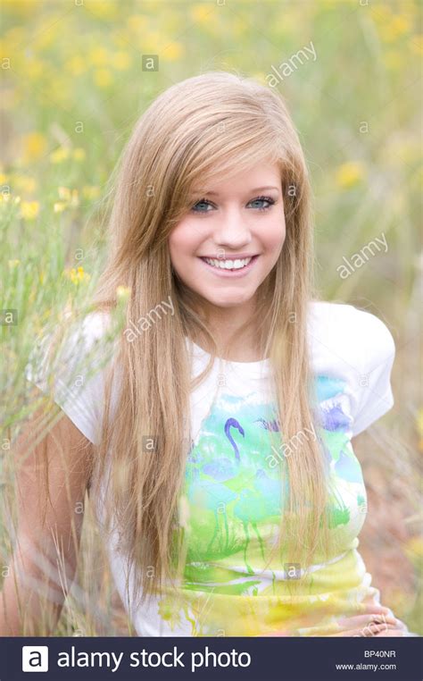 Portrait Of Teenage Girl 17 18 Years Old Sitting In Field