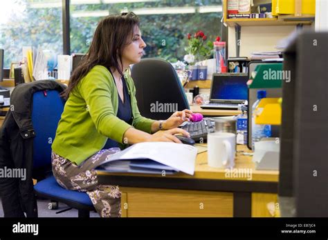 female teacher working   desk  staffroom stock photo alamy