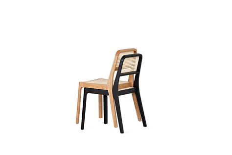 piaf stackable chair in hard wood and straw by tiago curioni brazilian