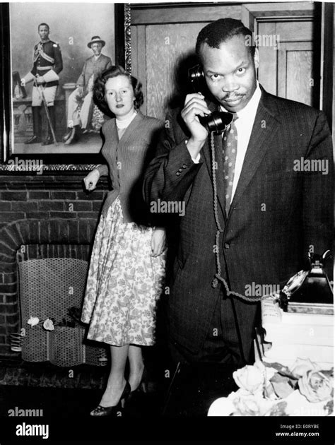 first president of botswana seretse khama right makes a telephone