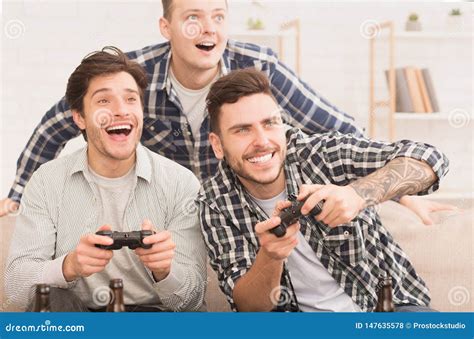 gamers happy friends playing video games  home stock photo image  home male