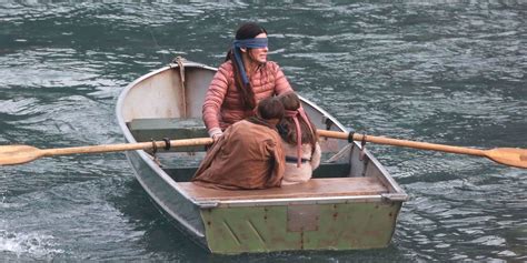 sandra bullock blindfolded in a post apocalyptic world in