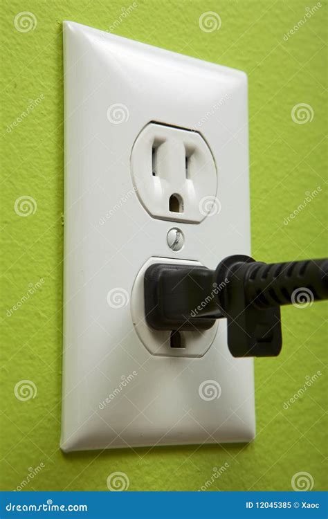 black cable plugged   white electric outlet royalty  stock photo image