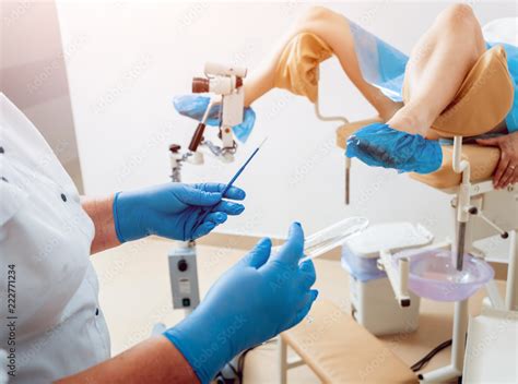 Woman In Gynecological Chair During Gynecological Check Up With Her