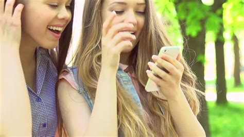 Three Female Friends Taking Selfie On Mobile Phone Shot