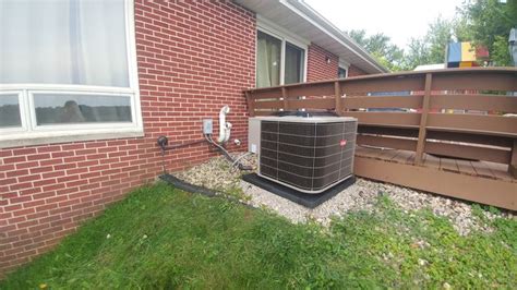 air conditioner sitting  front   brick house