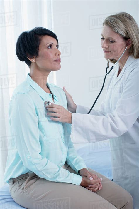 female doctor examining  patient  stethoscope  office stock