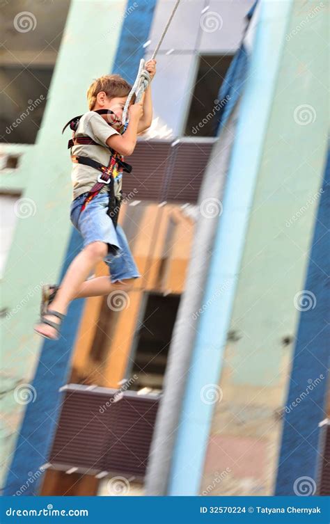 child boy sliding   fireman pole  playground stock image