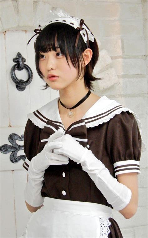 A Woman Dressed In Maid Clothing Posing For The Camera