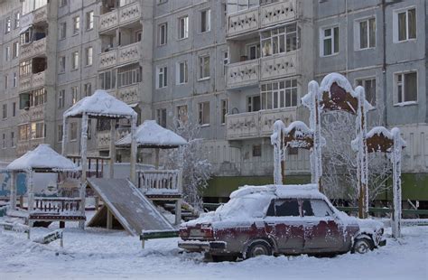 A Car Covered In Ice Is Pictured Near A Playground In