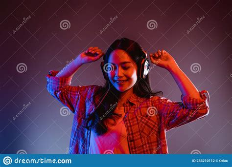 A Woman Closes Her Eyes While Listening To Music Wearing Headphones
