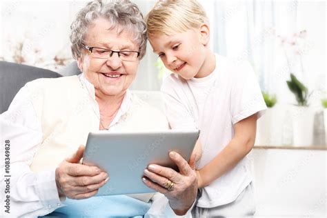 rodzina babcia  wnuczkiembabcia  wnukiem bawia sie na tablecie stock photo adobe stock