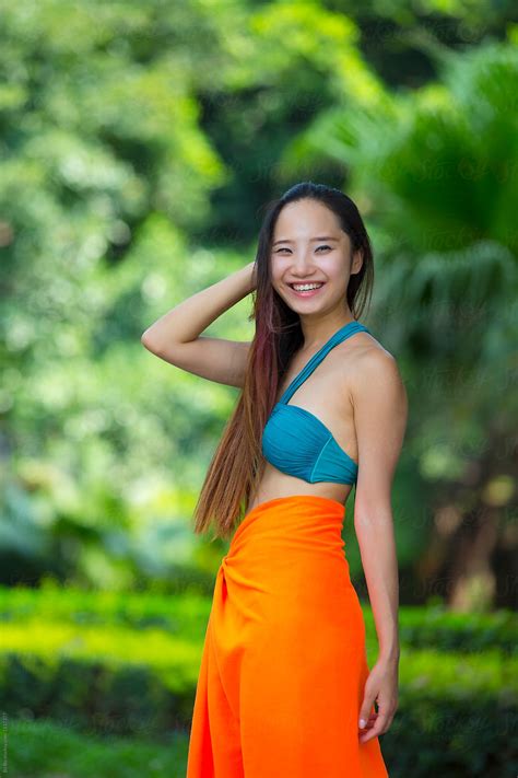pretty young asian  chinese woman wearing bikini   garden