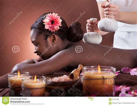 African American Woman Enjoying Herbal Massage At Spa Salon