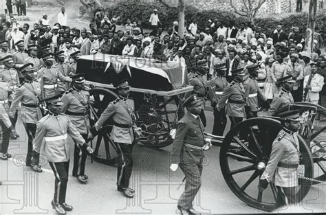 black  white photo  men  uniform standing    horse drawn carriage