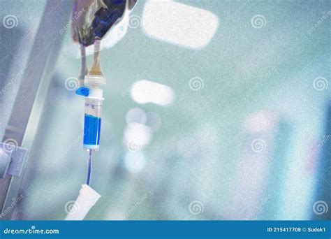 intravenous drip  blue content   pole   hospital hallway stock photo image