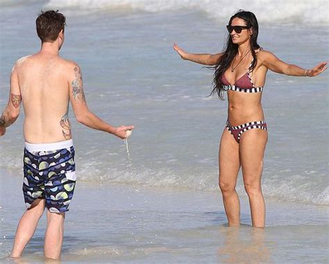 demi moore flaunts her enviable figure as she frolics on the beach with