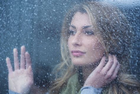 thoughtful woman   window  raindrops stockfreedom