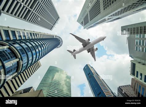 tall city buildings   plane flying overhead  morning stock photo