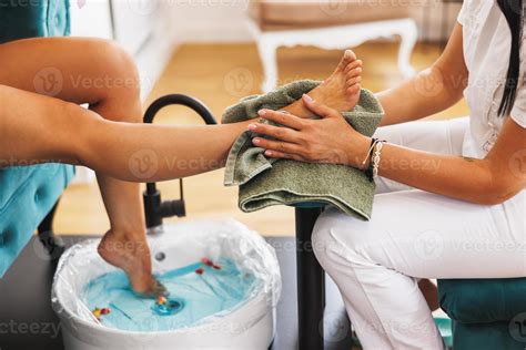 woman enjoying pedicure spa treatment   beauty salon  stock