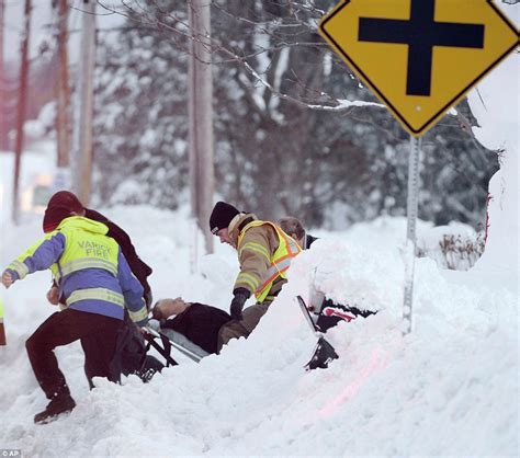 buildings collapse and thirteen die in snowstorm that has buried new york state in seven feet of