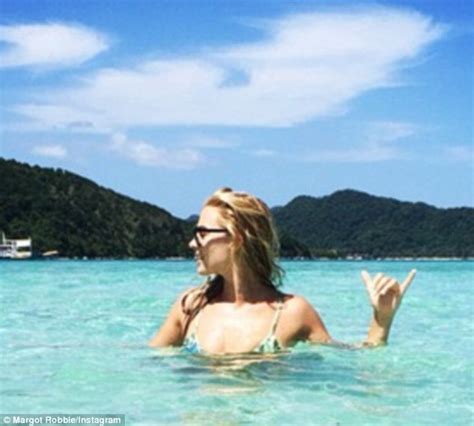 margot robbie covers bikini body immersed in green ocean in philippines daily mail online