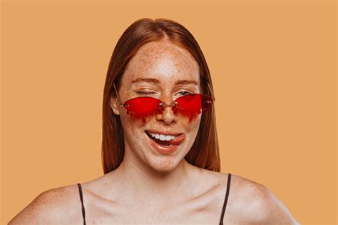 Redhaired Woman With Sunglasses Winks An Eye And Shows Her Tongue Stock