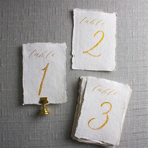 gold calligraphy wedding table numbers calligraphy table numbers