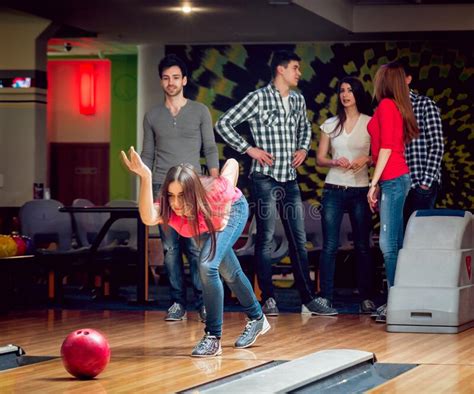 Cheerful Friends At The Bowling Alley With The Balls Stock Image