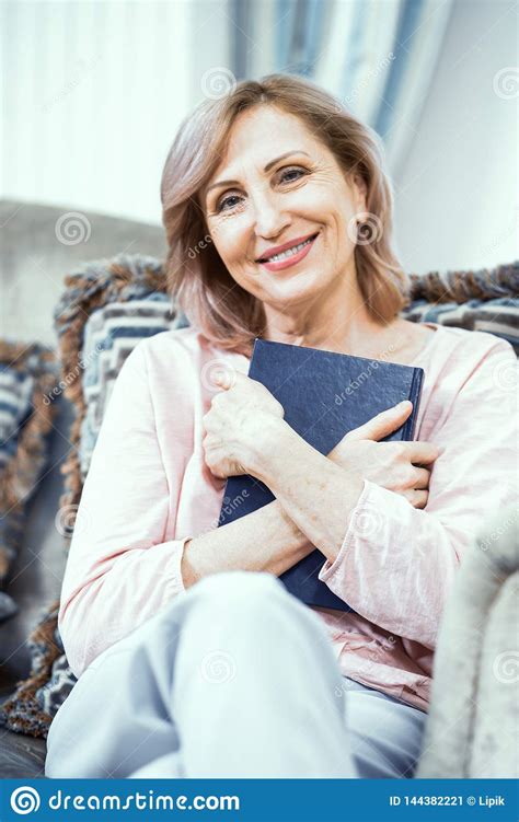 Beautiful Mature Woman Is Reading A Book Stock Image