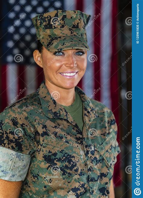 a united states female marine posing in a military uniform stock image