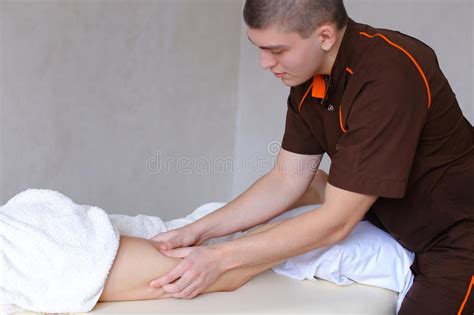 professional guy massage therapist by hand makes anti cellulite stock