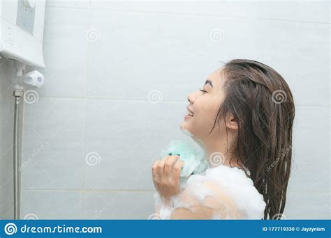 asian women portrait of happy girl taking shower with gel