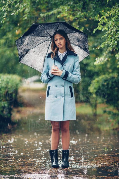 portrait  teenage girl holding umbrella  standing  pathway