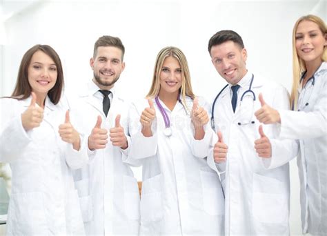 portrait  happy doctors team showing thumbs  stock photo image