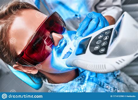 girl patient in the dental clinic teeth whitening uv lamp