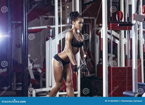 Brunette Fitness Girl In Black Sport Wear With Perfect Body In Gym