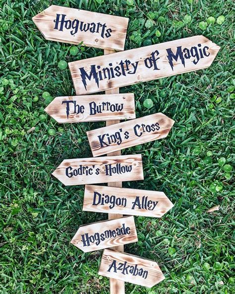 wooden directional signs pointing   direction  harry potters