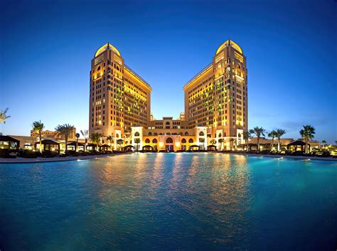 st regis doha hotel doha qatar resort night pool view travoh