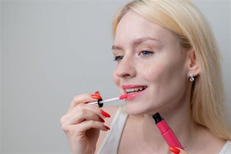 Beautiful Happy Young Blonde Woman With Freckles Holds Pink Lipstick In