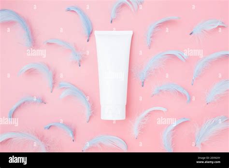 spa cosmetic product white cream tube  blue feathers  pink