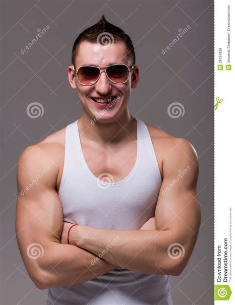 Muscular Man Wearing Black Sunglasses Posing Stock Image
